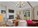 Bright living room featuring hardwood floors, a brick fireplace, and sliding doors to a patio at 205 Coachman Dr, Garner, NC 27529