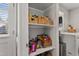 Walk-in pantry includes organized shelves, ample storage space, and bright, natural light at 205 Coachman Dr, Garner, NC 27529