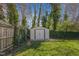 Well-maintained shed surrounded by greenery, providing additional storage in the spacious backyard at 205 Coachman Dr, Garner, NC 27529