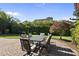 Outdoor dining area and landscaped backyard with patio at 205 Olive Field Dr, Holly Springs, NC 27540