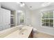 A well-lit bathroom features a spacious vanity with a large mirror and neutral finishes at 205 Olive Field Dr, Holly Springs, NC 27540