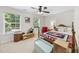 A bright bedroom decorated with cheerful colors and offering natural light from two windows at 205 Olive Field Dr, Holly Springs, NC 27540