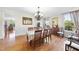 Formal dining room with hardwood floors, elegant chandelier, and classic furnishings at 205 Olive Field Dr, Holly Springs, NC 27540