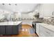 Modern kitchen featuring white cabinets, stainless steel appliances, and a large island at 205 Olive Field Dr, Holly Springs, NC 27540
