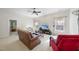 Bright living room featuring neutral walls, a ceiling fan, and plush carpet at 205 Olive Field Dr, Holly Springs, NC 27540