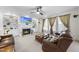Comfortable living room with a fireplace, built-in shelving, and plush leather seating at 205 Olive Field Dr, Holly Springs, NC 27540
