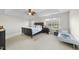 Bright main bedroom with a large bed, ceiling fan, and ample natural light from the windows at 205 Olive Field Dr, Holly Springs, NC 27540