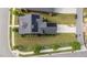 Aerial view of a house with solar panels, landscaping, and a driveway in a residential neighborhood at 2057 Big Falls Dr, Wendell, NC 27591