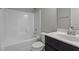 Bright bathroom featuring a shower-tub combo with white tile and a sleek black vanity at 2057 Big Falls Dr, Wendell, NC 27591