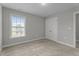 Cozy bedroom with plush carpeting, a window, and a double door closet at 2057 Big Falls Dr, Wendell, NC 27591
