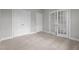 Neutral bedroom features carpeting, closet doors, and french doors to an adjacent room at 2057 Big Falls Dr, Wendell, NC 27591