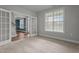 This is a bedroom featuring neutral walls, carpeting, and open french doors at 2057 Big Falls Dr, Wendell, NC 27591