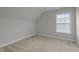 Upstairs bedroom features carpeting, neutral walls, and a sunlit window at 2057 Big Falls Dr, Wendell, NC 27591