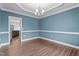 Dining room with modern chandelier and accent wall, offers seamless access to the kitchen at 2057 Big Falls Dr, Wendell, NC 27591