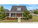 Charming home featuring a red front door, stone accents, a manicured lawn, and fresh landscaping at 2057 Big Falls Dr, Wendell, NC 27591