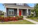 Close up of attractive exterior with gray siding, white trim and bright red front door with stone accent columns at 2057 Big Falls Dr, Wendell, NC 27591