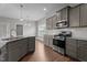 Bright kitchen offering stainless steel appliances, a granite countertop island, and ample cabinet space at 2057 Big Falls Dr, Wendell, NC 27591