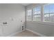 Functional laundry room with tile floors, utility hookups, and natural light from windows at 2057 Big Falls Dr, Wendell, NC 27591
