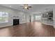 Open concept living area with hardwood flooring, a fireplace, and plenty of natural light at 2057 Big Falls Dr, Wendell, NC 27591