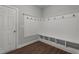 Functional mudroom boasts a built-in bench with cubbies, wood-look flooring and crisp white trim at 2057 Big Falls Dr, Wendell, NC 27591