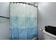 Simple bathroom with a shower-tub combination and a blue patterned shower curtain at 206 Cottrell Dr, Louisburg, NC 27549