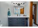 Charming bathroom with a vanity, modern lighting, and adjacent doorway at 206 Cottrell Dr, Louisburg, NC 27549