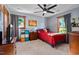 Cozy bedroom featuring natural light from two windows, ceiling fan, and tasteful decor at 206 Cottrell Dr, Louisburg, NC 27549