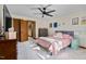 Inviting bedroom with comfortable bed, ceiling fan, and natural light from the window at 206 Cottrell Dr, Louisburg, NC 27549