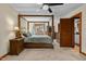 Cozy bedroom with a four-poster bed, soft carpet, and natural light from the window at 206 Cottrell Dr, Louisburg, NC 27549