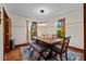 Bright dining room with a wooden table, bench, chairs, and stylish lighting at 206 Cottrell Dr, Louisburg, NC 27549