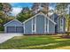 Beautiful blue home with large garage and well-manicured lawn, perfect for outdoor enjoyment at 206 Cottrell Dr, Louisburg, NC 27549