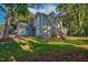 Charming two-story home with a well-manicured lawn and mature trees at 206 Cottrell Dr, Louisburg, NC 27549