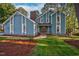 Charming blue two-story home featuring bright white trim and a brick chimney at 206 Cottrell Dr, Louisburg, NC 27549