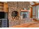 A close-up of the brick fireplace including wood storage and log storage at 206 Cottrell Dr, Louisburg, NC 27549
