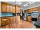 Spacious kitchen with stainless steel appliances, wooden cabinets, and blue backsplash at 206 Cottrell Dr, Louisburg, NC 27549
