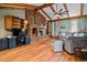Living room with a vaulted ceiling, brick fireplace, hardwood floors, and a desk area at 206 Cottrell Dr, Louisburg, NC 27549