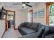 Inviting living room with a plush sectional couch and ceiling fan for ultimate comfort at 206 Cottrell Dr, Louisburg, NC 27549