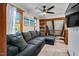 Comfortable living room showcasing a sectional couch, built-in bookshelves, and a staircase at 206 Cottrell Dr, Louisburg, NC 27549