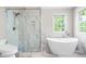 Modern bathroom showcasing a glass-enclosed shower and an elegant free-standing bathtub with fixtures at 206 Glebe Way, Cary, NC 27519