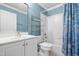 Full bathroom with blue accents, a sink, toilet, bathtub, shower and shower curtain at 206 Glebe Way, Cary, NC 27519