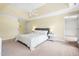 Bright bedroom with a large bed, ceiling fan, and access to the walk-in closet and bathroom at 206 Glebe Way, Cary, NC 27519