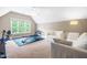Bonus room with exercise equipment, sofas, a ceiling fan, and a large window with natural light at 206 Glebe Way, Cary, NC 27519