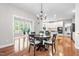 Cozy dining room with hardwood floors and a chandelier, adjacent to the kitchen at 206 Glebe Way, Cary, NC 27519
