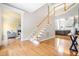 Bright foyer features hardwood floors, fireplace view, staircase, and an open floor plan at 206 Glebe Way, Cary, NC 27519