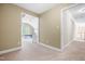 Hallway featuring doorways leading to adjacent rooms with neutral wall colors and carpeted flooring at 206 Glebe Way, Cary, NC 27519