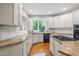 Bright eat-in kitchen with granite countertops, stainless steel appliances, and a garden view at 206 Glebe Way, Cary, NC 27519