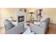 Cozy living room featuring a fireplace, hardwood floors, and comfortable seating at 206 Glebe Way, Cary, NC 27519