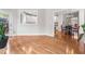 Open-concept living room features gleaming hardwood floors and a view into the kitchen and dining areas at 206 Glebe Way, Cary, NC 27519