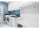 Well-organized mudroom with white cabinets, counter space, and laundry appliances at 206 Glebe Way, Cary, NC 27519