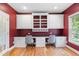 Bright office space with custom built-in cabinets, a desk, and two chairs at 206 Glebe Way, Cary, NC 27519